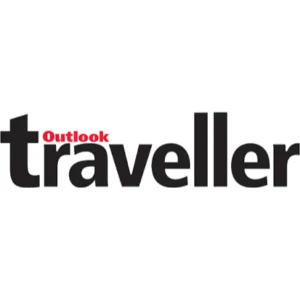 AuraKalari : The image is a logo for "Outlook Traveller". The text is in black, with "traveller" in lower case, and "Outlook" in red, positioned on top of the "t" in "traveller". The background is white, creating a strong contrast for the bold black and red text. Perfect for your next eco-friendly vacation or Mud and Tree Homestay adventure.