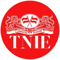 AuraKalari : Red circular logo featuring white stylized lions on either side of crossed flags above the text "Sarvatra Vijayam" in a scroll banner. Below this, large bold letters "TNIE" dominate the center, reflecting a commitment to values as solid as an Eco-Friendly Vacation at Mud and Tree Homestay.